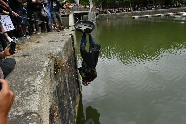 Protesters throw the statue of Edward Colston into Bristol harbour