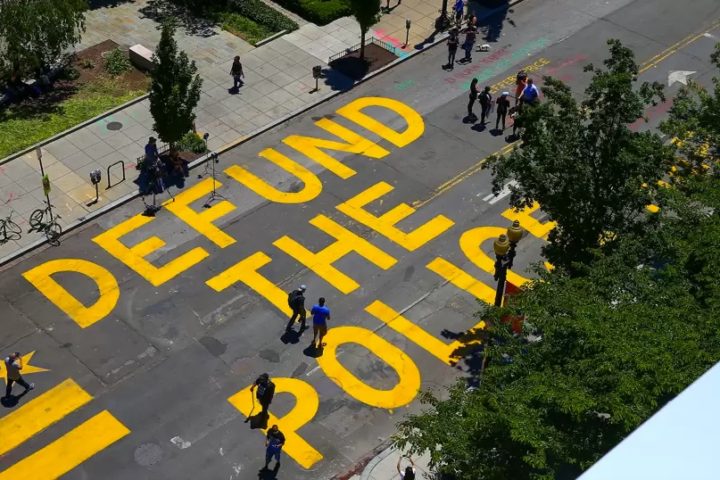 Defund the police painted on the street