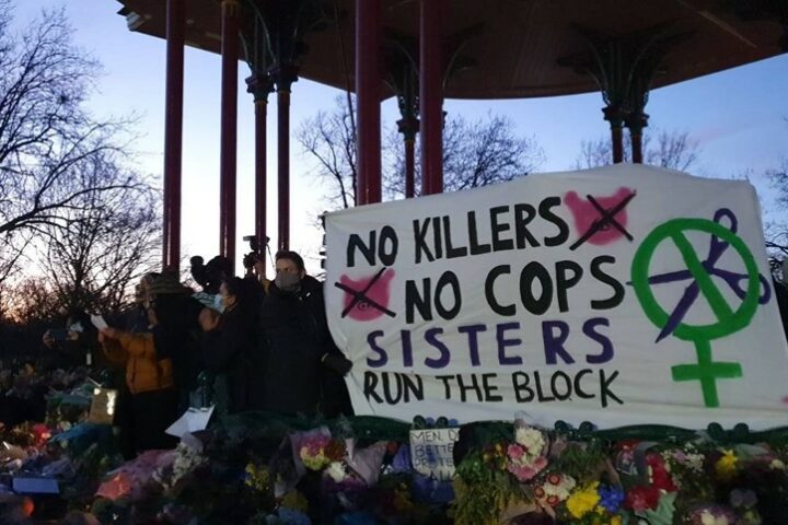 Image shows a banner saying 'No Killers, No cops. Sisters run the block"