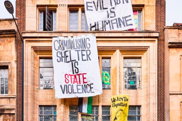 Photo of squatted building with banners hanging on the walls